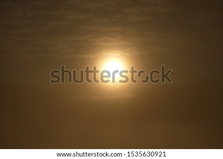 Bright big sun on the sky with yellow orange gradient colors
in Thailand.