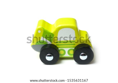 Closeup of miniature toy, wooden green car on white background