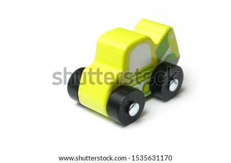 Closeup of miniature toy, wooden green car on white background