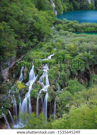 Beautiful waterfall floating from the blue lake on the mountain in Plitvice national park Croatia