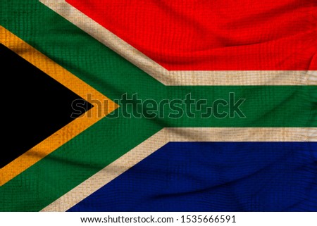 photo of the beautiful colored national flag of the state of South Africa on textured fabric, concept of tourism, economy and politics, closeup