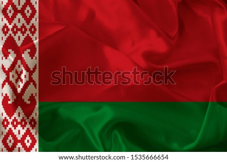beautiful photo of a colored national flag of the modern state of Belarus on a textured fabric, concept of tourism, emigration, economy and politics, closeup