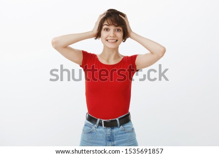 Geez no way I won. Cheerful lucky positive lovely girl short haircut hold hands head smiling happily surprised celebrating good news receive awesome prize successfully finish exams white background