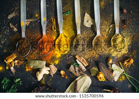 Picture of various spices with black background.