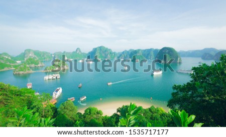 Halong Bay, a world heritage, with a beach, ships, mountains, trees, and an ocean. The landscape was taken on the top of TI TOP Island in Vietnam Royalty-Free Stock Photo #1535717177