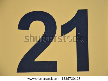 Number 21 with black digits on a yellow plate