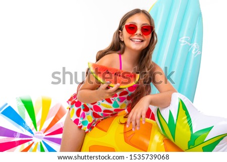 positive girl in a swimsuit with a wide smile on her face, summer vacation, fruit fresh