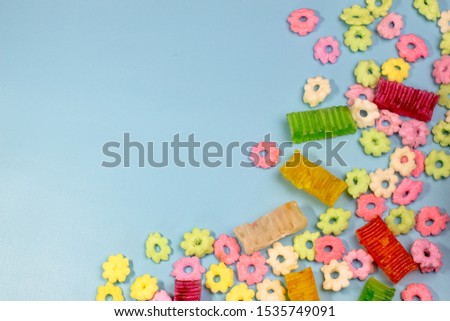 colorful cereal and block candy with free space on a blue background