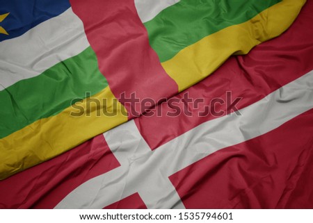 waving colorful flag of denmark and national flag of central african republic. macro