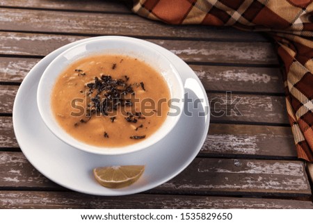 Woman hands holding bowl of vegetable soup