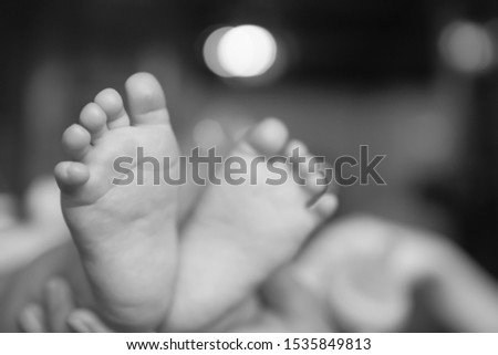 Soft focus of close up little feet of the baby with blurred background, look like heart.