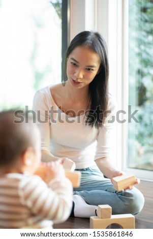 Young woman playing with baby