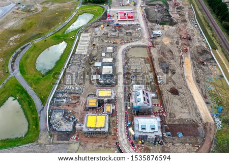 Aerial photo of a construction building site building houses, taken in Leeds in the UK showing a housing development with houses being built.
