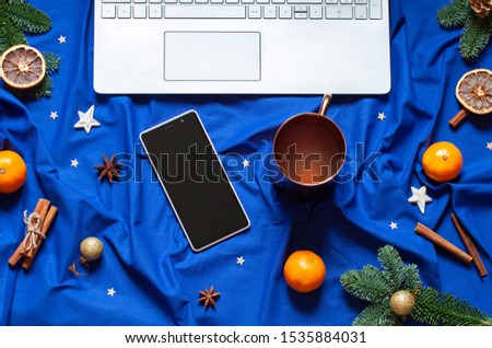 Blue Christmas New Year flat lay on the bed blanket with the laptop keyboard. Winter holiday festive card. Top view
