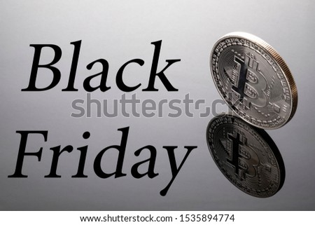 silver bitcoin reflection on black Friday.