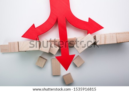 Arrow Breaking Through Wall Made Of Wooden Blocks On White Background