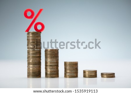 Interest Rate Decreasing Graph Made Of Stacked Coins