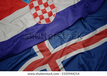 waving colorful flag of iceland and national flag of croatia. macro