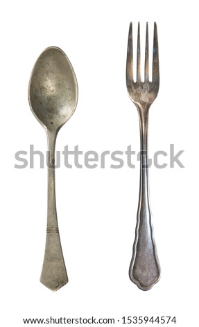Vintage spoon and fork isolated on a white background. Retro silverware.
