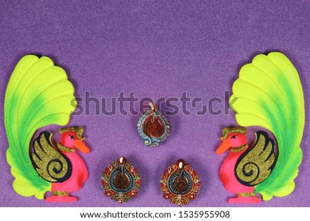 Deepawali Diwali Celebrations with Diya Peacock and Decorations Purple Background