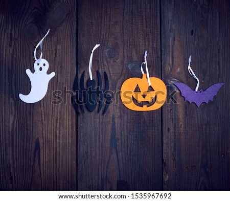 colorful felt figures on a wooden background, festive backdrop for Halloween