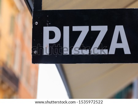 Pizza sign exposed on the a busy street