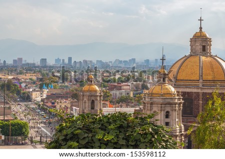 Old Basilica of Guadalupe with Mexico City skyline behind it Royalty-Free Stock Photo #153598112