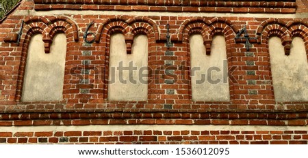 Wrought-iron anchor plates in the form of digits – to be read as the year 1614 – in a brick facade. Produced that year