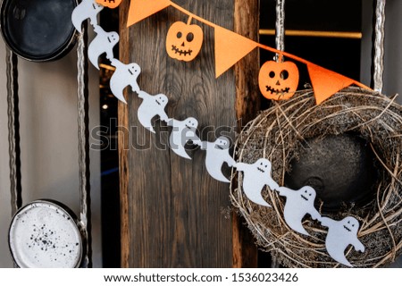 Happy halloween holiday concept. Halloween decorations, pumpkins and ghosts