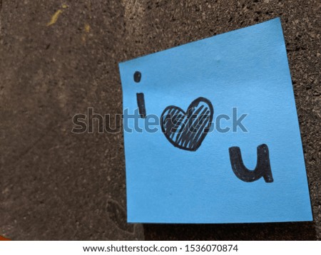 The words "i love you" on a paper