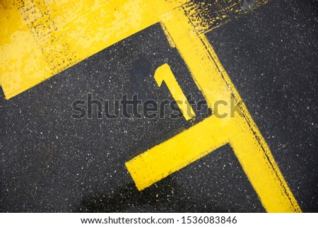 Asphalt abstract background with yellow lines and number one, reviews, race start numver one, DTM, Norisring Royalty-Free Stock Photo #1536083846
