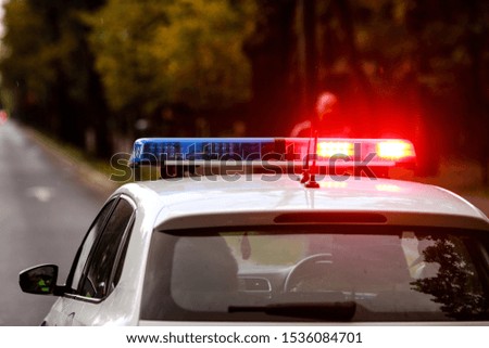 Details with the red and blue lights siren on top of a police car