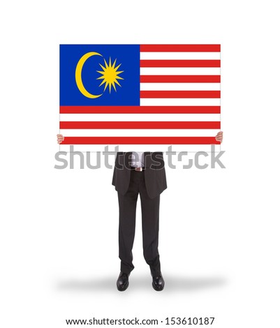 Businessman holding a big card, flag of Malaysia, isolated on white