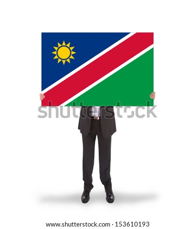 Businessman holding a big card, flag of Namibia, isolated on white