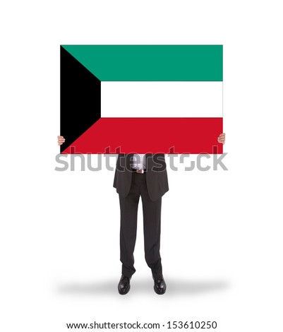 Businessman holding a big card, flag of Kuwait, isolated on white