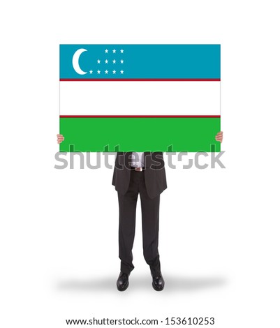 Businessman holding a big card, flag of Uzbekistan, isolated on white