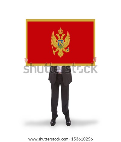 Businessman holding a big card, flag of Montenegro, isolated on white