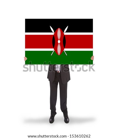 Businessman holding a big card, flag of Kenya, isolated on white