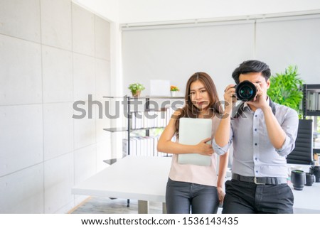Happy Young woman and man photography smiling confidence, a couple take photo studio shot, office business content creator photography with each other, business success modern, photography concept