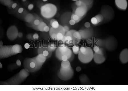 Abstract background white bokeh dispersion on a black background