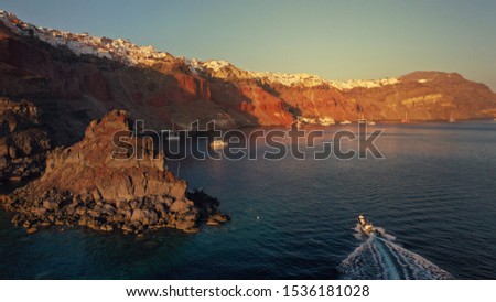 Aerial panoramic photo of iconic and famous for sunset village of Oia, Santorini island at sunset, Cyclades, Greece