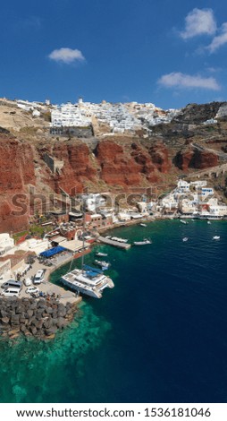 Aerial panoramic photo of iconic and famous for sunset village of Oia, Santorini island at sunset, Cyclades, Greece