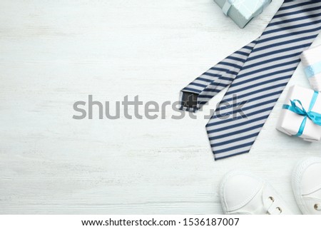 Flat lay composition with man's accessories and gift box on white wooden background. Space for text
