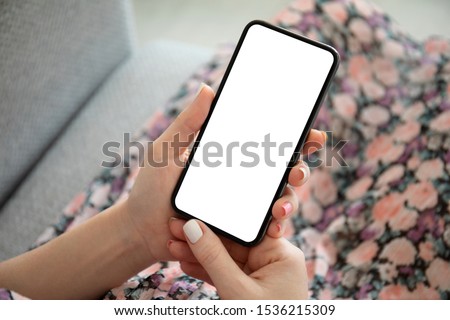 woman in multi colored dress holding phone with isolated screen