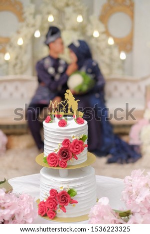 The bride couple  wearing Malay traditional  cloth  eats or Makan Beradab with their family  in wedding ceremony . Happy & Family Concept