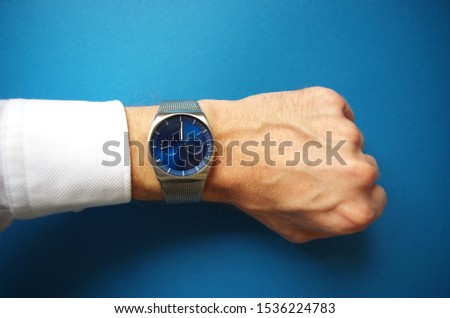Business man pointing at hand watch, success and business concept, time management