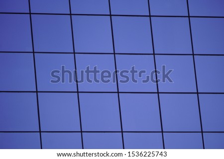glass Windows repeating geometric pattern. part of a modern building. skyscraper