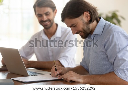 Happy satisfied businessman client customer sign bank loan service contract job employment agreement at business meeting get hired buy insurance make financial deal concept writing signature on paper