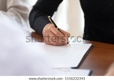 Male customer client write signature on business document sign contract agreement on table make commercial financial sale purchase deal buy insurance doing paperwork management concept, close up view Royalty-Free Stock Photo #1536232343