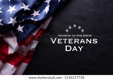 Happy Veterans Day. American flags with the text thank you veterans against a blackboard background. November 11. Royalty-Free Stock Photo #1536237728